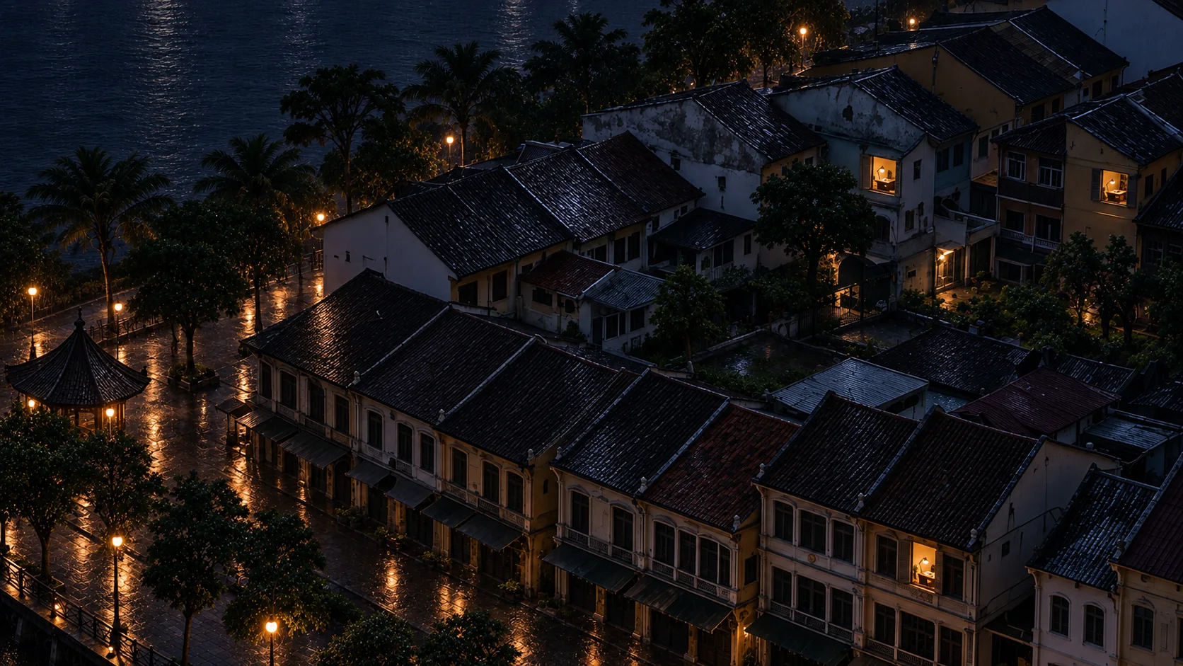 The Kuching waterfront at midnight in the rain, three windows lit in three different shophouses